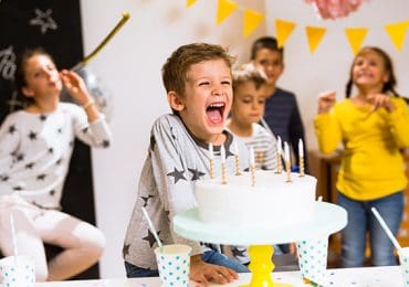 child enjoying party after parents taking precautions to avoid serious allergic reaction